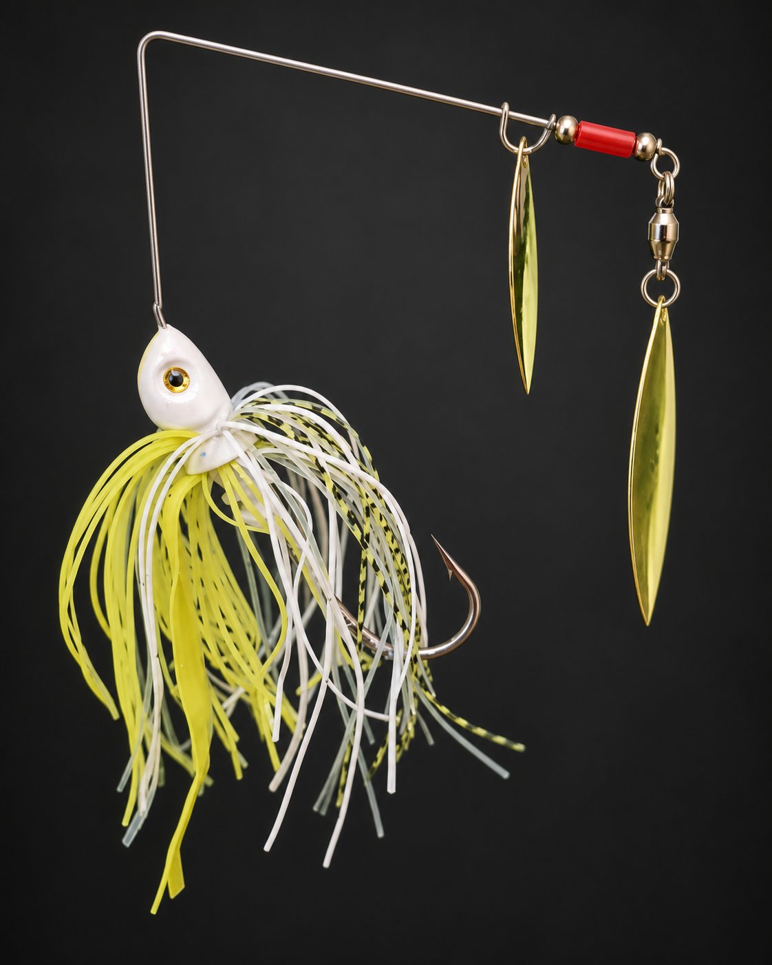 White and chartreuse spinnerbait, with the head on the left, an inward-facing hook and two gold willow blades on the right.